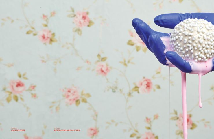 Film still from Chapter 2: A Wet Bio by Coder Better Lovers, Hsin-Yu Chen. A hand wearing a surgical blue glove is holding a white, strangely textured ball dripping with pink slime, on a floral wallpaper background. 